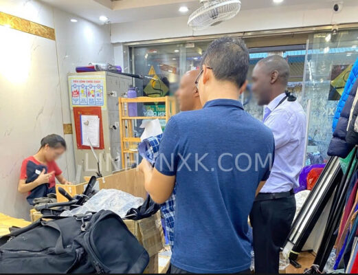 Returning customer bringing a friend to shop for men's clothing at LinhVNXK in Hanoi